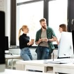 Marketing Mastery: 6 Strategies to Elevate Your Social Media Game Young concentrated colleagues in office talking with each other