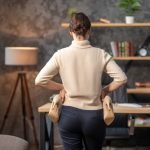 How Chiropractic Posture Tips Help You Relax Naturally? Woman holding high-heeled shoes in her hands