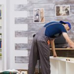 How to Assemble Ready-to-Assemble (RTA) Cabinets Easily Furniture assembly worker standing reading instruction
