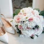 Mixing and Matching Accessories Across Wedding Themes wedding bouquet in bride's hands