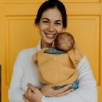Benefits of Adding Natural Lactation Powders to Daily Meals Smiling woman holding her baby.