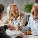 7 Benefits of Estate Planning for Your Family Senior couple signing a contract while having a meeting with insurance agent in the office.